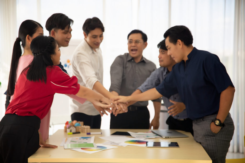 Close up on hands of business people join together on unity concept outdoor team building malaysia | They are having the indoor grouping activities to solve on the problems