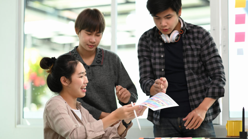 Group of young designers meeting and brainstorming in meeting ro outdoor team building activities malaysia | mmt provide the indoor stimulation activities for teambuilding training course