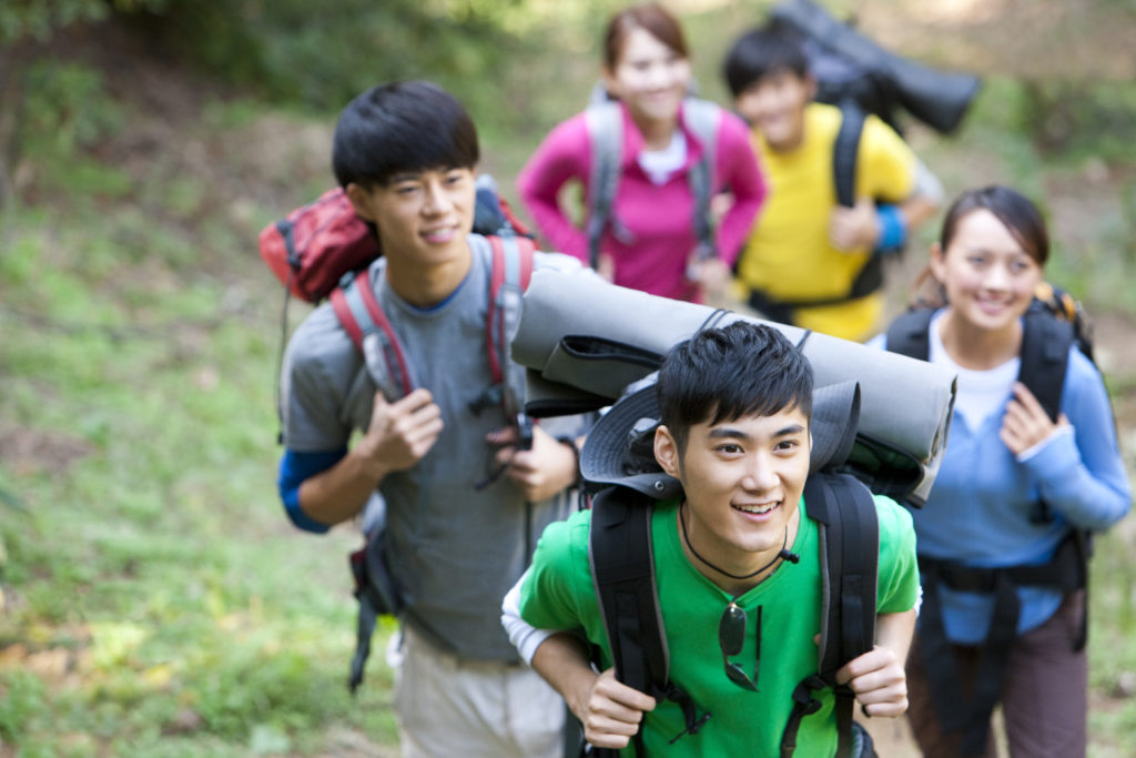 Young Chinese go hiking in mountain outdoor team building activities malaysia | A bunch of students are having the bonding activities by mmt